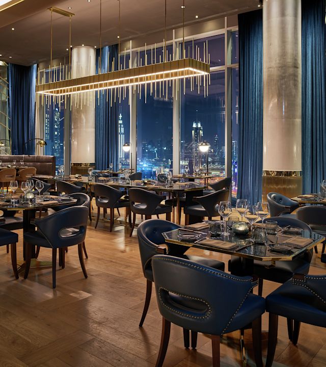 Bull & Bear seating with Dubai skyline at night