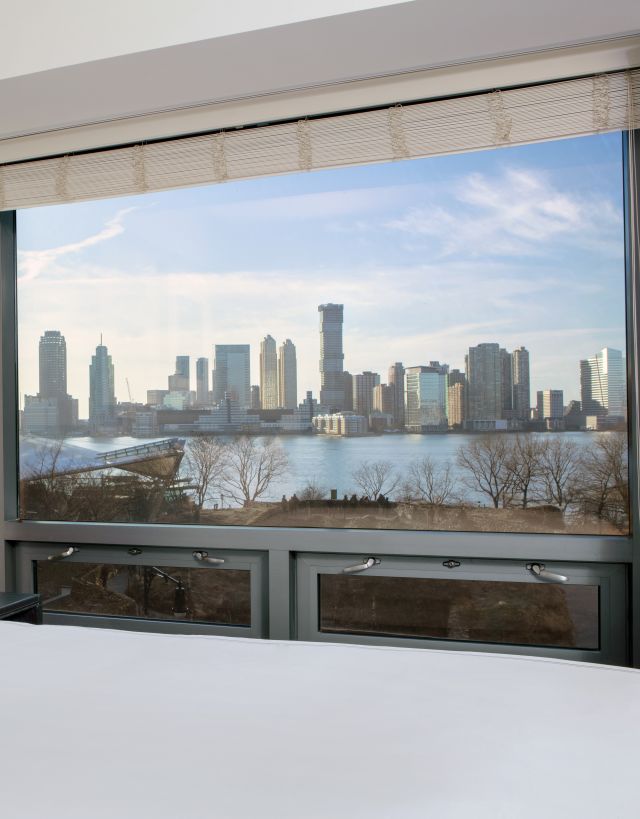 Bed in room with view of skyline