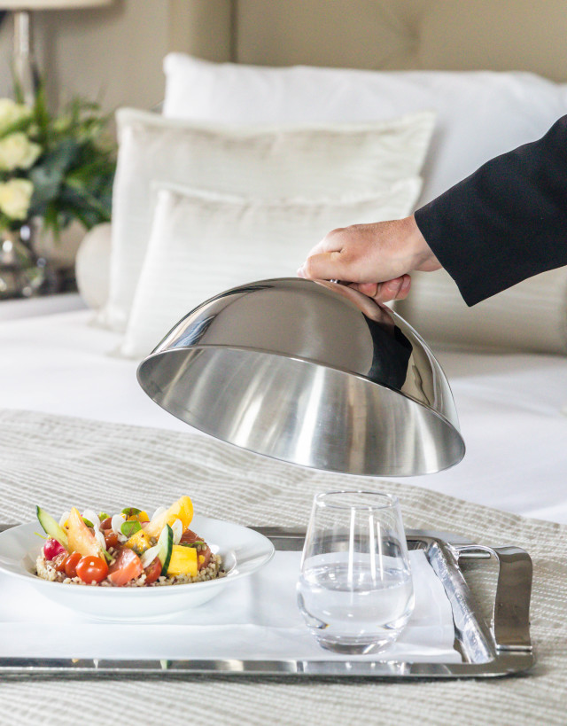 Room service tray with staff member