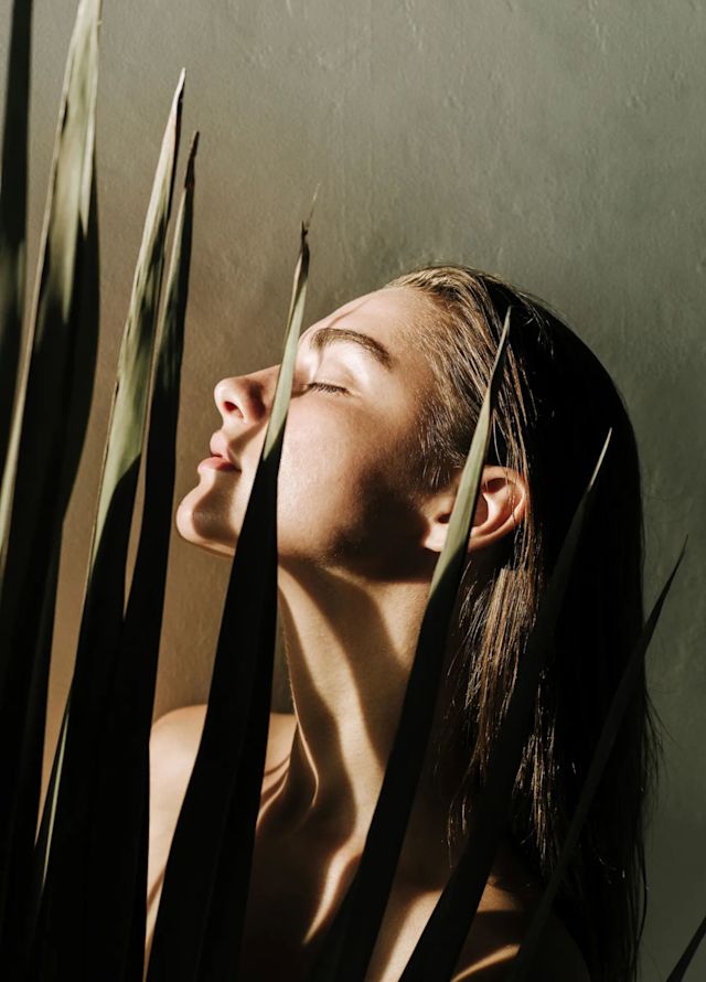 Women with plant and shadow over her face