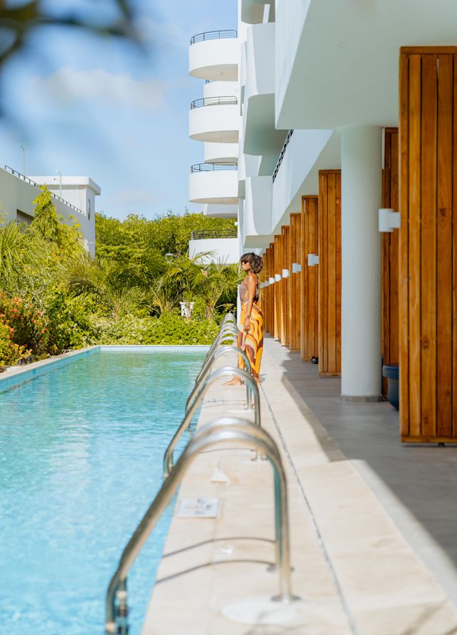 female guest standing by the outdoor pool