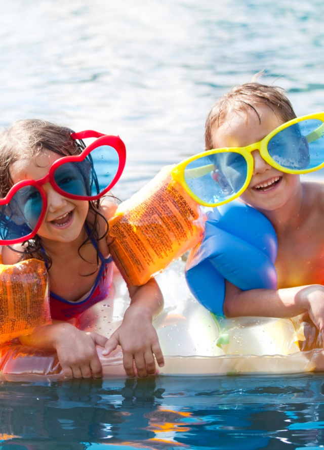 Kids in pool with large sunglasses