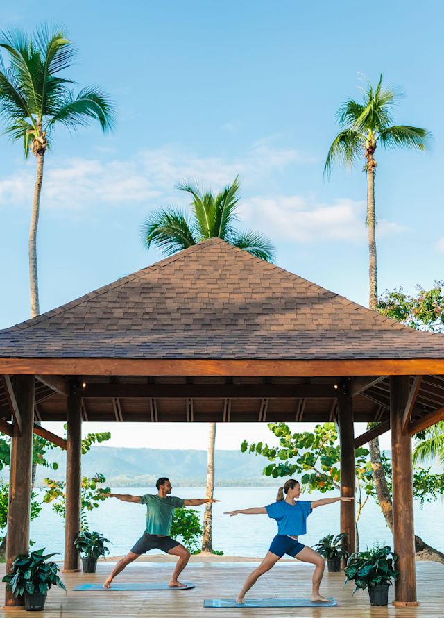 Yoga mats set under a beach gazebo facing the ocean