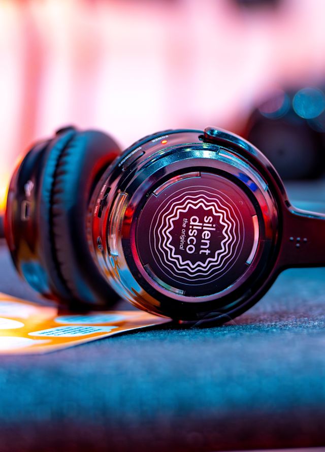 Headphones on table with 'silent disco' written on the side