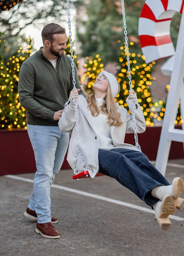 Couple Enjoying an Endearing Swing Experience during Christmas Time