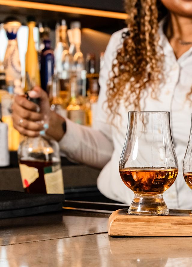 Bartender is serving drinks at SER Steak + Spirits