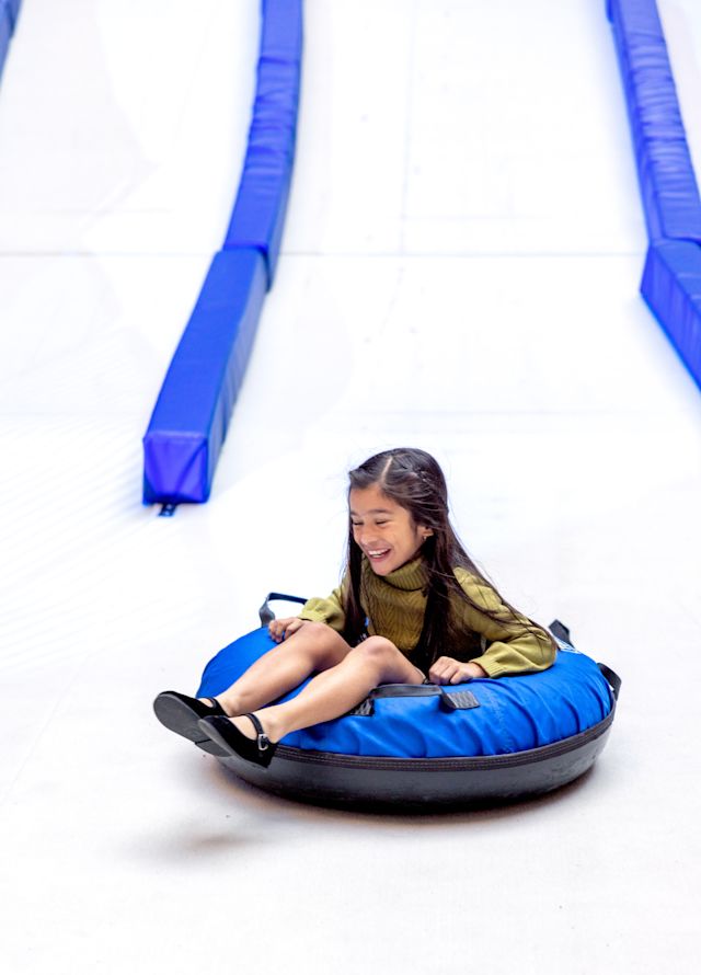Girl Riding an Inflatable River Tube Outdoors