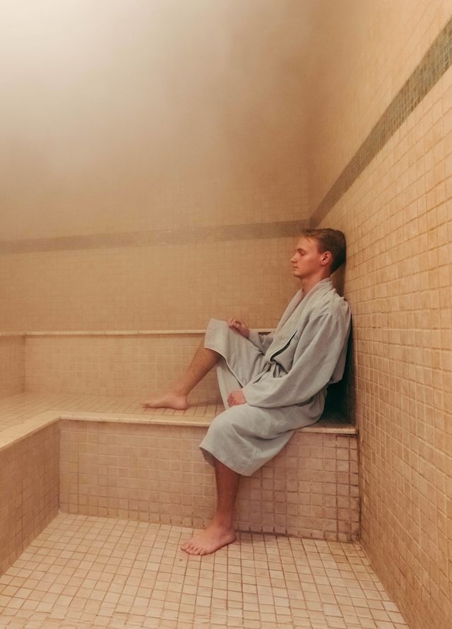 Man in robe relaxing in a steam room