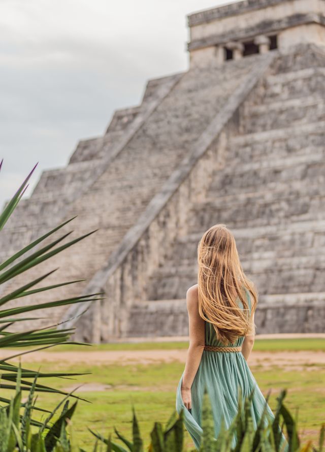 Person standing in front of Mayan ruins