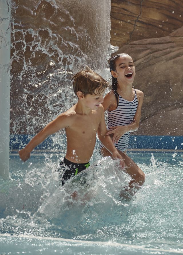 Boy and girl playing in pool