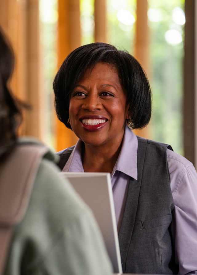 Front desk agent welcoming a guest