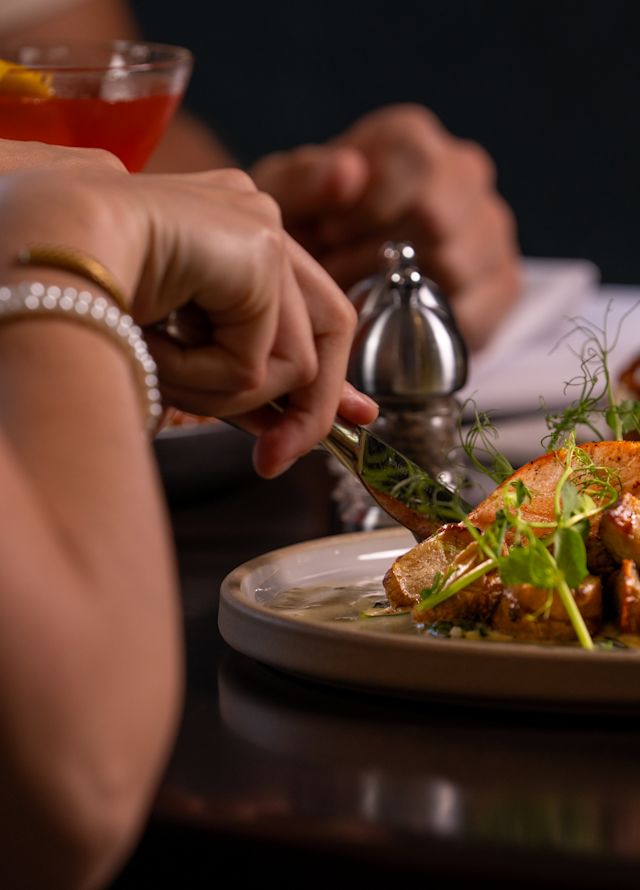 A woman enjoying salmon for dinner