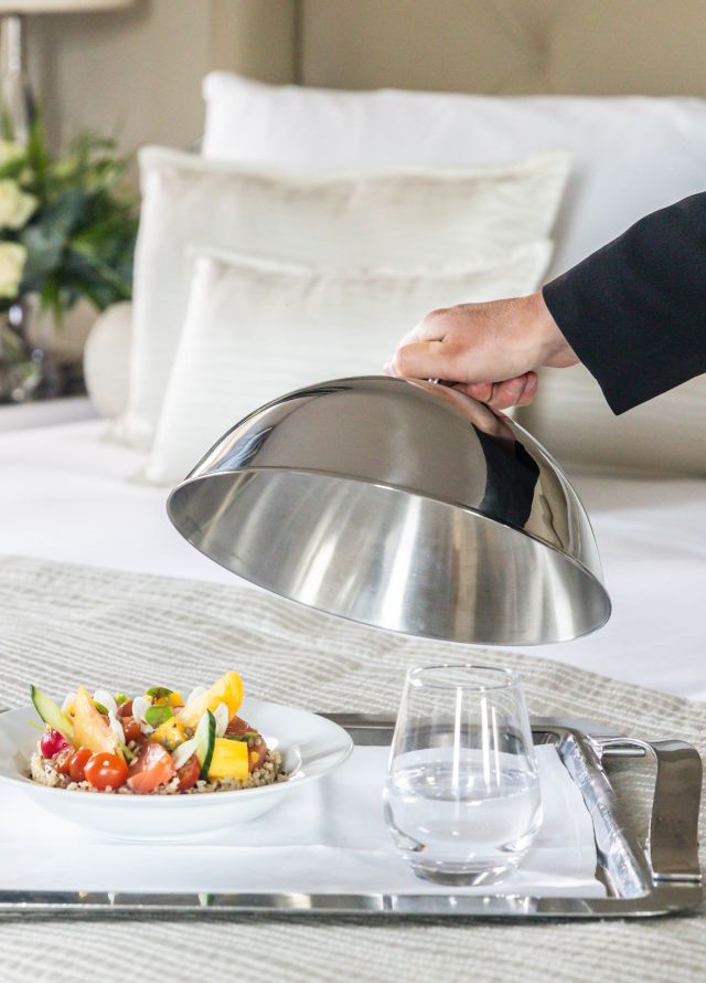 Room service tray with staff member
