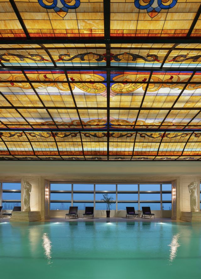 Indoor pool with ornate ceiling