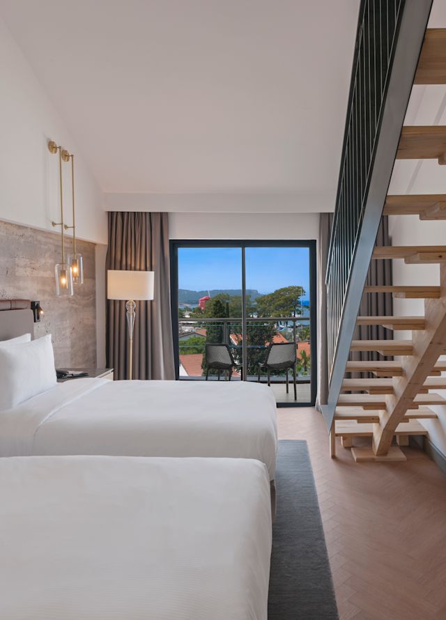 Room with Bed, TV, Work Desk, and Balcony