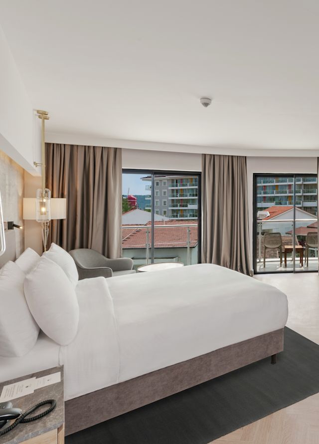 A large white bed in a bedroom