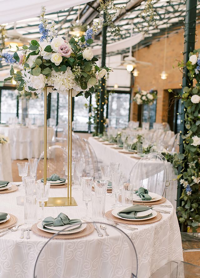 Wedding Celebration in a Space Decorated with Flowers and Round Tables