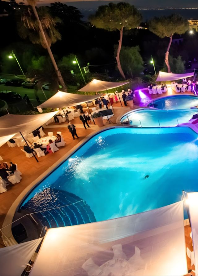 Outdoor Pool Area at Night Decorated with Colorful Lights