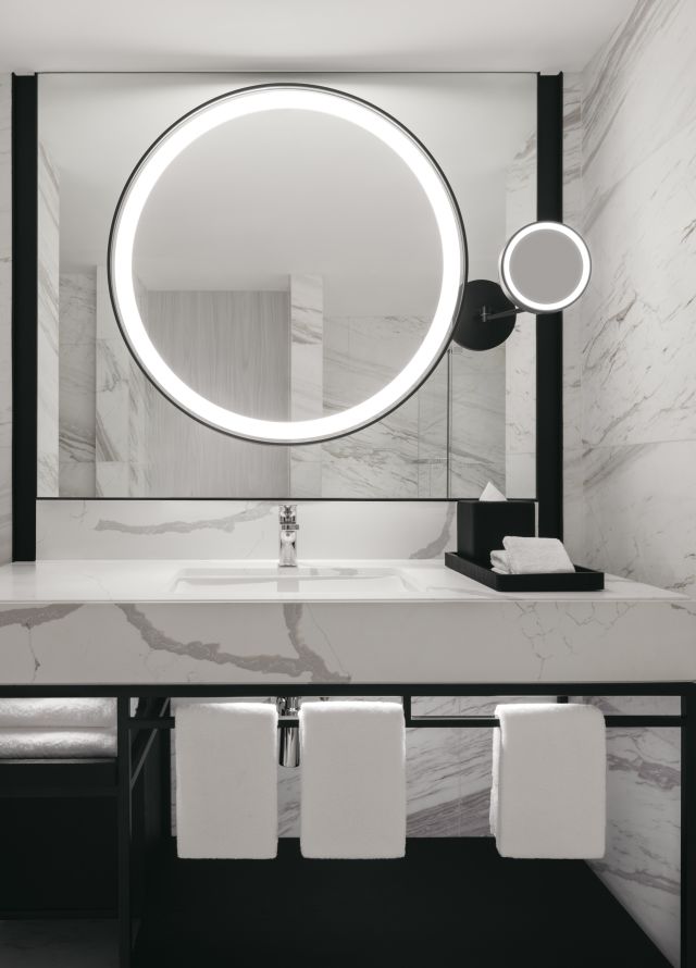 One bedroom suite bathroom sink and vanity with tub