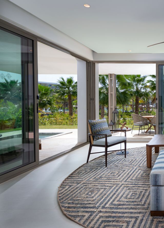 Suite Living Room with Pool Area and Partial View of the Ocean