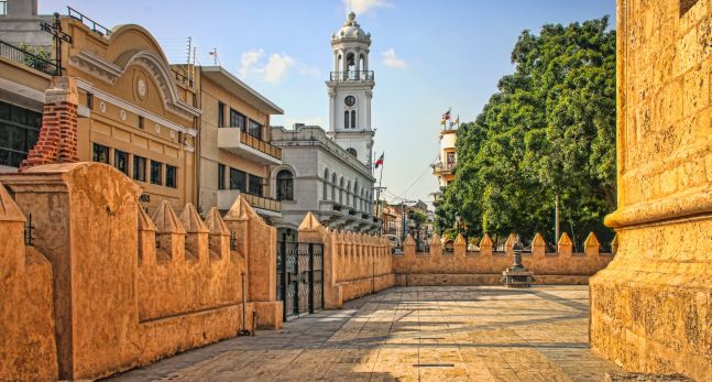 Historic City Center Plaza with skyline of Colonial buildings and church in Santo Domingo, Dominican Republic.