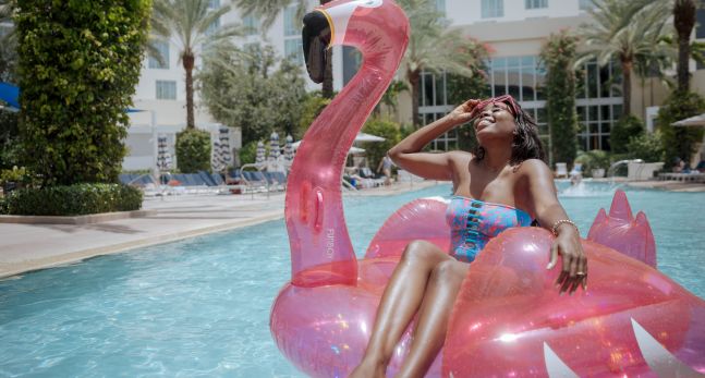 a Woman Sitting on an Inflatable Toy at the Pool