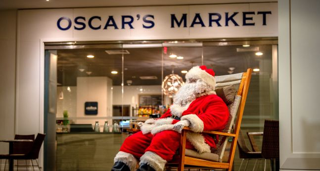 Santa on deck chair in-front of Oscar's market