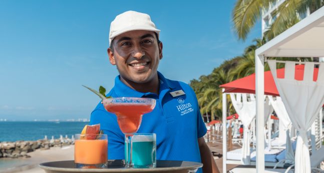 waiter serving drinks at the outdoor pool