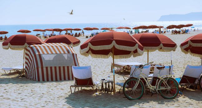 Beach scene with umbrellas, bike and beach chairs