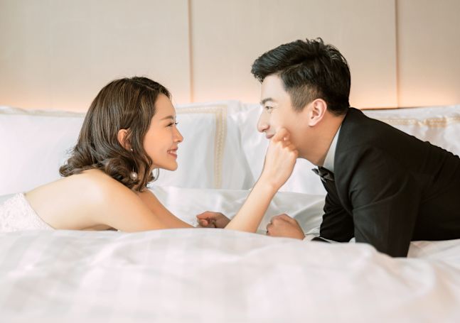 Bride & Groom Lying on Bed