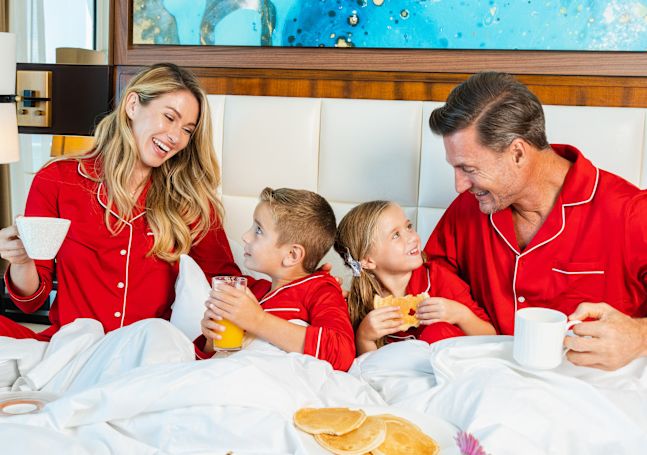 Family Having Breakfast in Bed