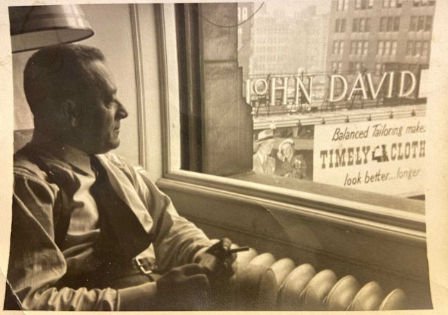 Old Photo of a Man Looking to the Street from a Guest Room Window