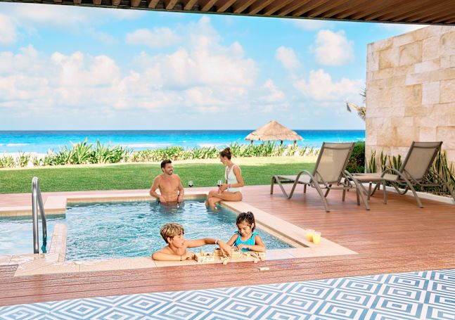 Family playing in plunge pool in the suite.