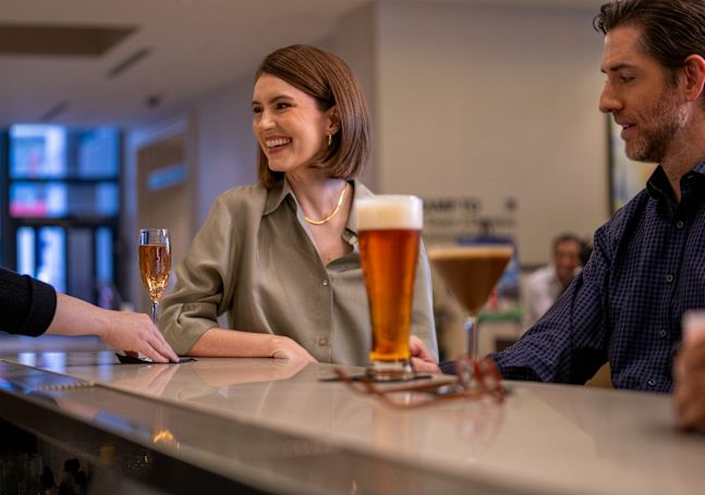Bartender Serving Drinks to Guests at the Lobby Bar