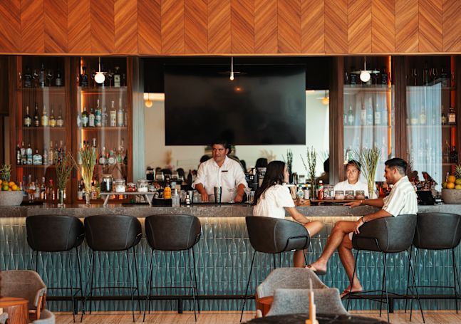 Man and woman sitting at bar area