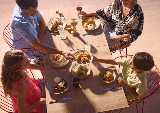 Mother, father, daughter and son having dinner