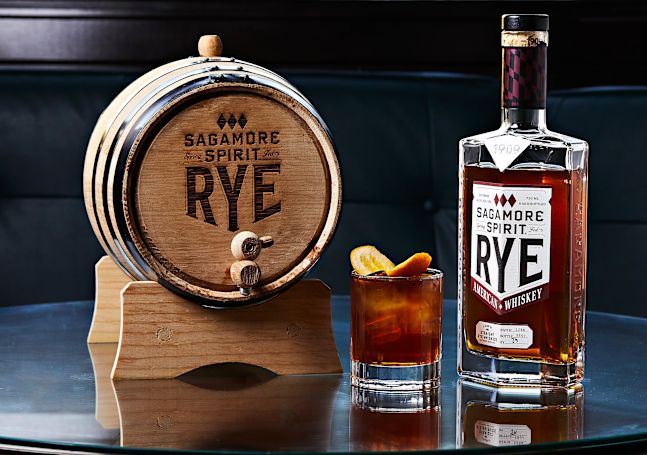 Sagamore Spirit Rye Whiskey in a small barrel next to a glass