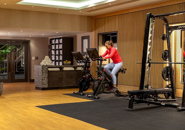 a Woman on an Exercise Bike in a Fitness Center
