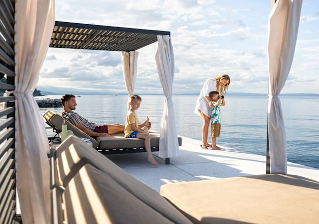 Family relaxing by water