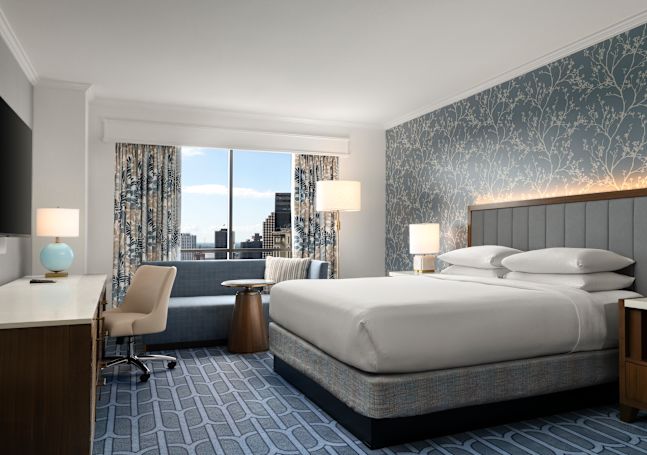 Large Bed, Sofa and Desk in a Guest Room