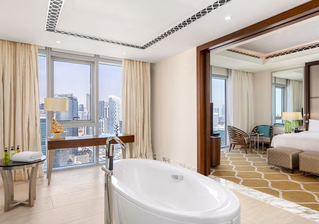 Suite Bathroom with Bathtub and Partial View of Separate Bedroom
