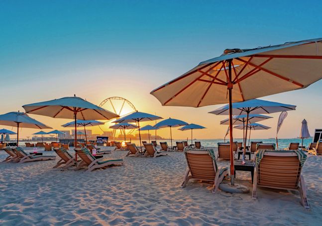 View of Beach with Sun Loungers under Beach Umbrellas