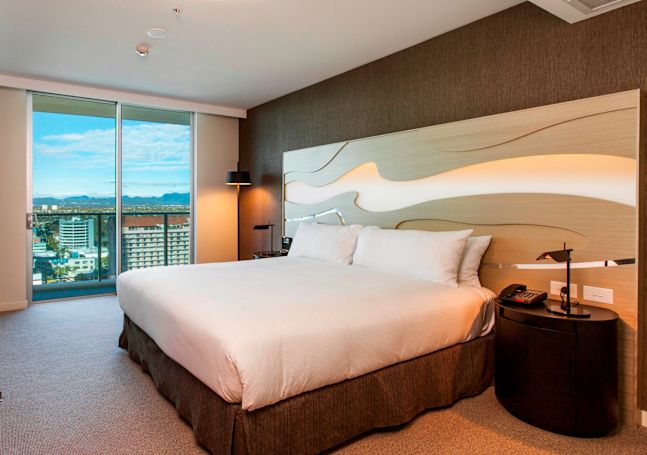 King-Sized Bed, Large Window and Desk in Guest Room