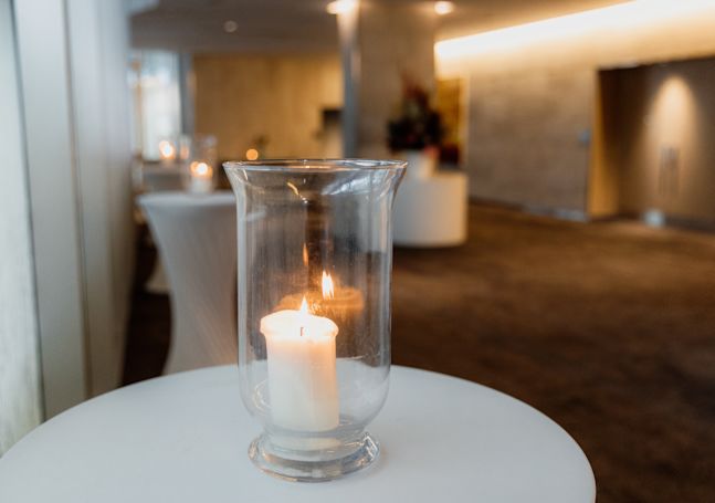 Closeup of a lit candle in a glass jar