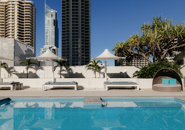 outdoor pool, lounge chairs, umbrellas