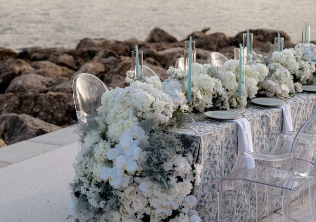 Table Setup with Candles and Flowers for a Wedding Celebration at the Beach