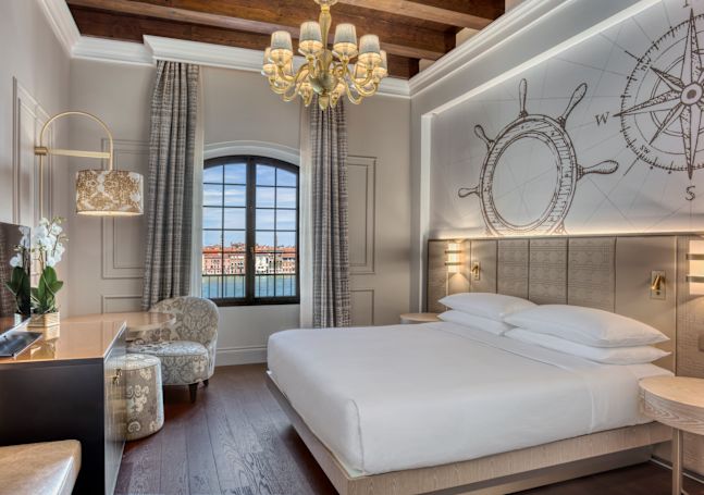 Guest Room with Large Bed HDTV and Windows with City View