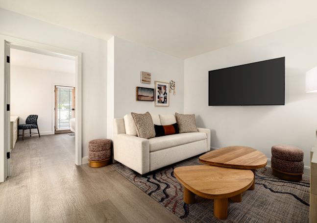 Junior suite living room area with sofa, coffee table, and TV