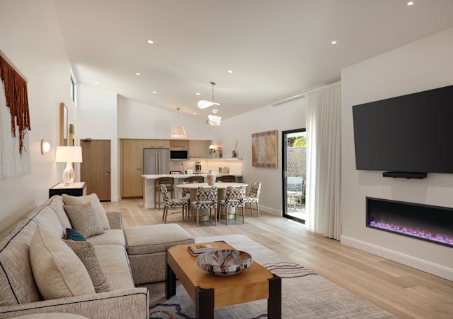 Suite living area with a fireplace, TV, and a full kitchen.