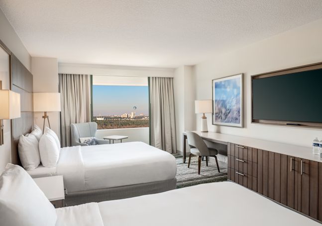 Double Queen Room with Two Beds, TV, Work Desk, and Outside View